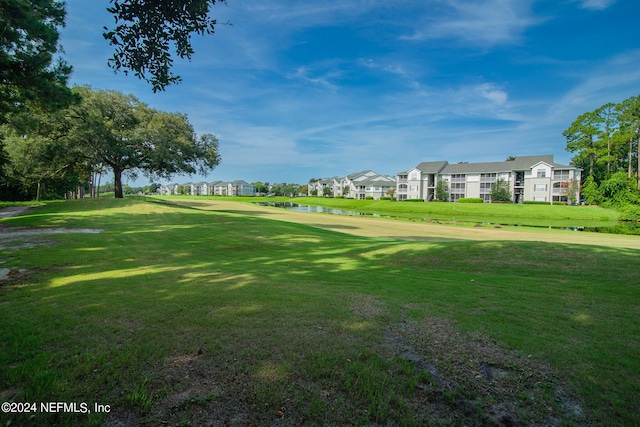 surrounding community featuring a yard