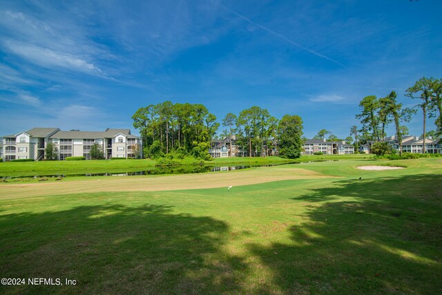 view of home's community with a yard