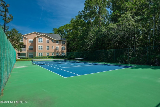 view of sport court featuring fence