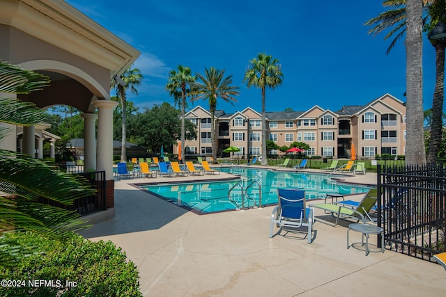 pool featuring a patio and fence