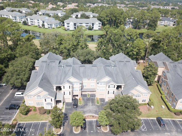 birds eye view of property with a water view and a residential view