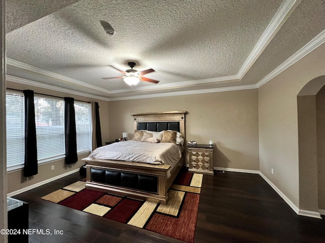 bedroom featuring baseboards, arched walkways, ceiling fan, ornamental molding, and dark wood-type flooring