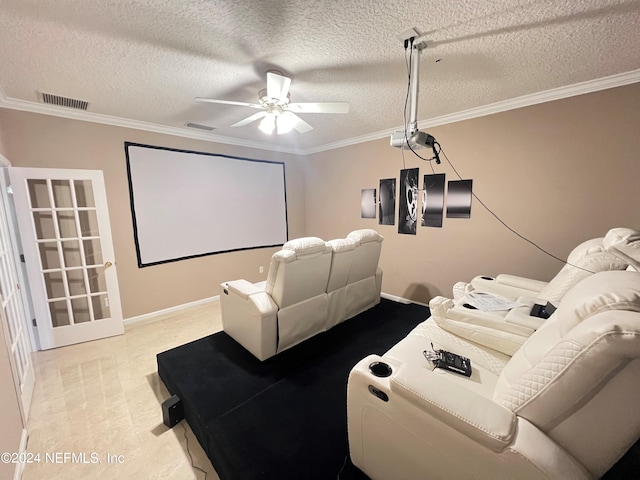 cinema room with visible vents, ceiling fan, ornamental molding, a textured ceiling, and light floors