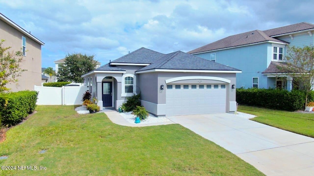 view of front of property featuring a front yard and a garage