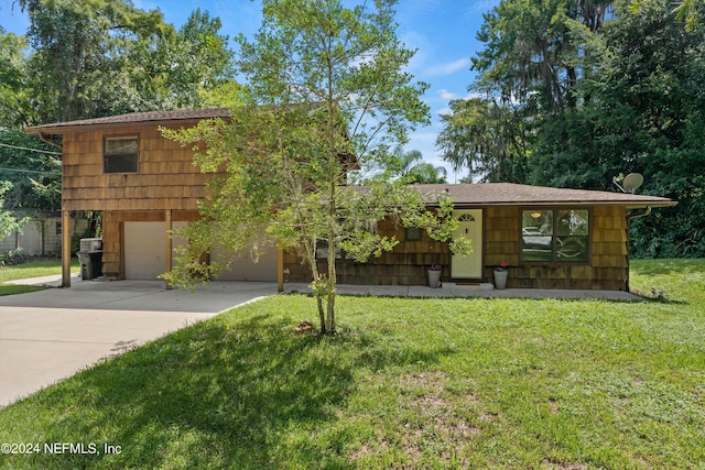 view of front of home with a garage and a front yard