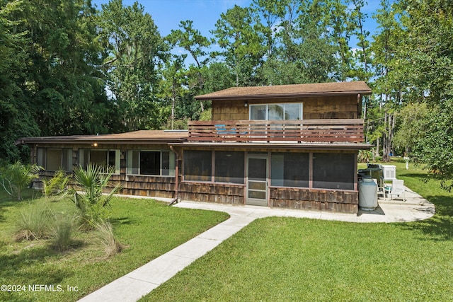 back of house featuring a sunroom and a yard