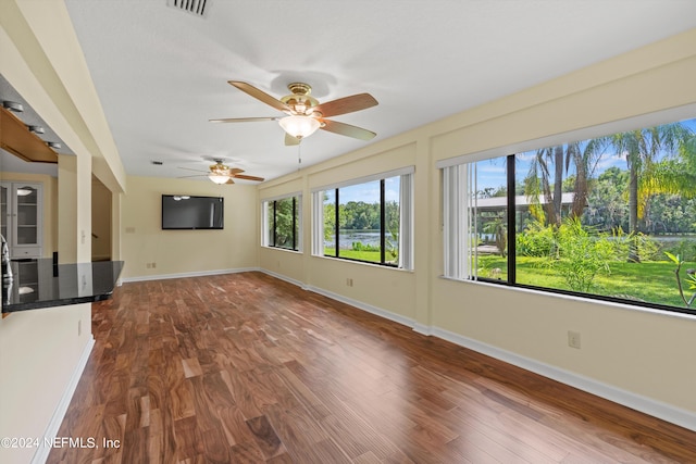 unfurnished sunroom featuring ceiling fan