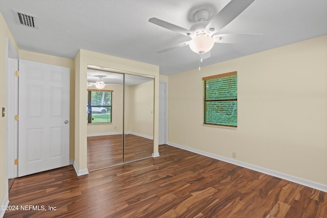 unfurnished bedroom featuring ceiling fan, hardwood / wood-style flooring, and a closet