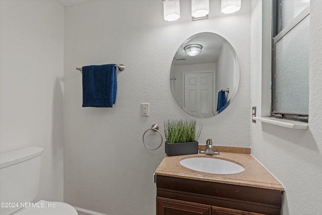 bathroom with vanity and toilet