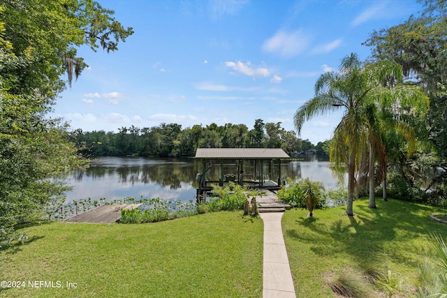 dock area with a yard and a water view