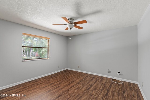 spare room with a textured ceiling, hardwood / wood-style flooring, and ceiling fan