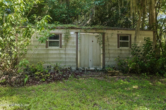 view of outbuilding with a yard