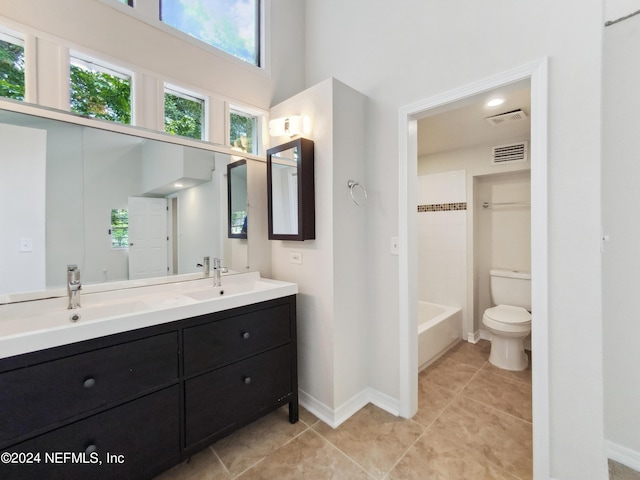 full bathroom featuring vanity, toilet, and  shower combination