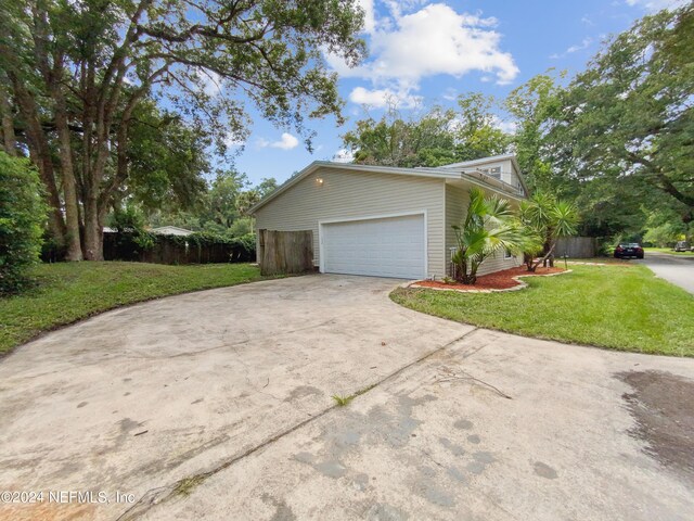 view of side of property with a garage and a yard