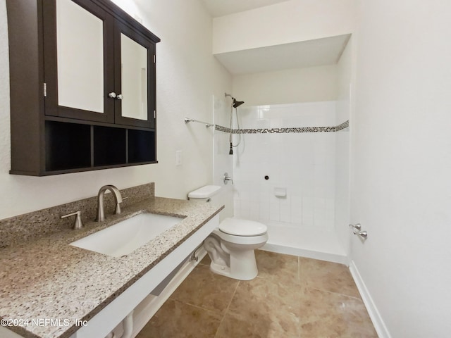 bathroom with tile patterned flooring, toilet, sink, and walk in shower