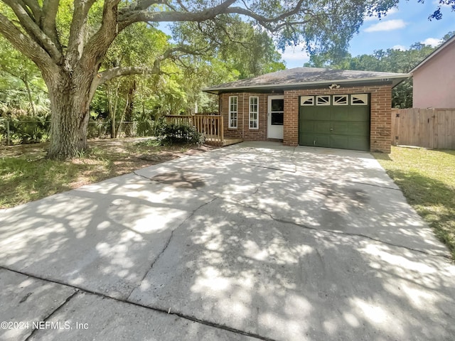 view of property exterior featuring a deck and a garage