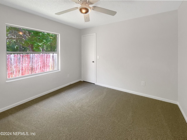 carpeted empty room with a textured ceiling and ceiling fan
