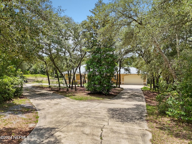 view of property's community with a garage