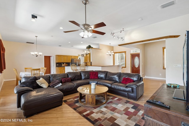 living room with light wood-type flooring and ceiling fan with notable chandelier