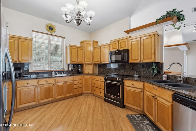 kitchen featuring appliances with stainless steel finishes, light hardwood / wood-style flooring, sink, and backsplash