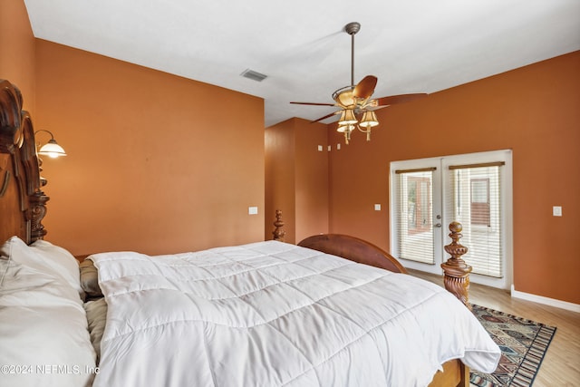 bedroom featuring ceiling fan, light hardwood / wood-style floors, access to exterior, and french doors