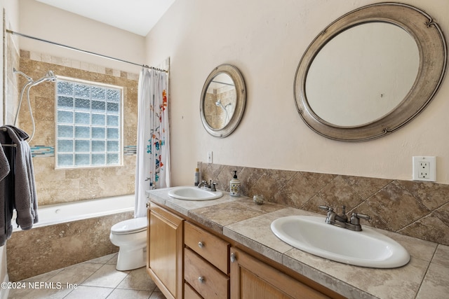 full bathroom with tile patterned flooring, toilet, double vanity, and shower / tub combo