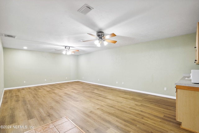 spare room with ceiling fan and light hardwood / wood-style flooring