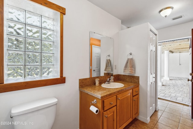 bathroom with tile patterned floors, vanity, and toilet