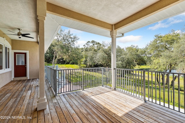 wooden deck featuring ceiling fan