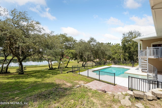 view of swimming pool with a patio and a lawn