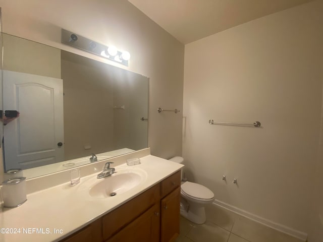 bathroom with tile patterned floors, vanity, and toilet