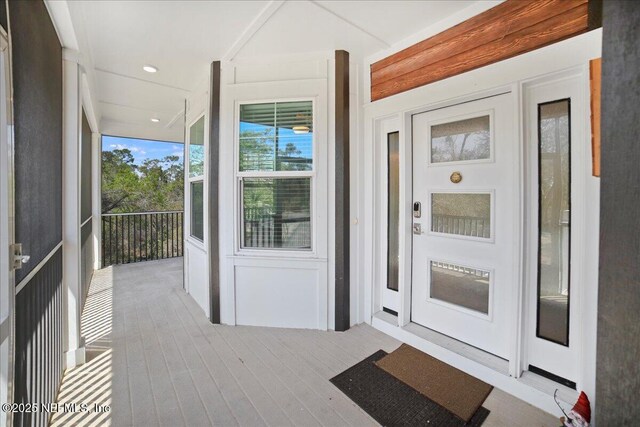 49 SW 279th Ave, Steinhatchee, FL 32359 - view of exterior entry featuring covered porch and stucco siding