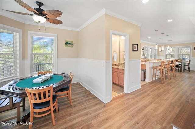 49 SW 279th Ave, Steinhatchee, FL 32359 - dining area with ornamental molding, light wood-style floors, ceiling fan, and wainscoting