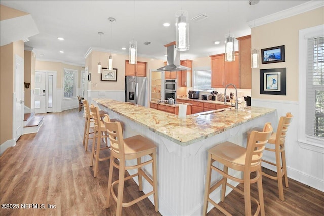 49 SW 279th Ave, Steinhatchee, FL 32359 - kitchen with a peninsula, ornamental molding, stainless steel appliances, island range hood, and light wood-type flooring