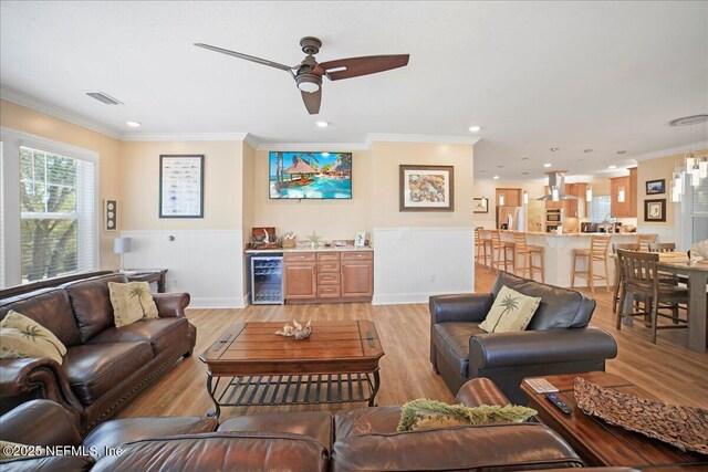 49 SW 279th Ave, Steinhatchee, FL 32359 - living area with wine cooler, a ceiling fan, light wood-type flooring, visible vents, and ornamental molding
