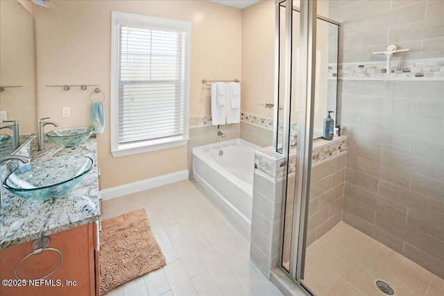 49 SW 279th Ave, Steinhatchee, FL 32359 - full bathroom featuring a stall shower, double vanity, a sink, and a garden tub