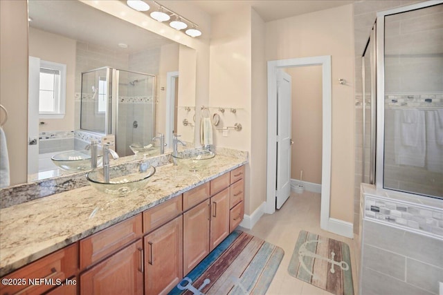 49 SW 279th Ave, Steinhatchee, FL 32359 - bathroom with double vanity, a sink, baseboards, and a shower stall