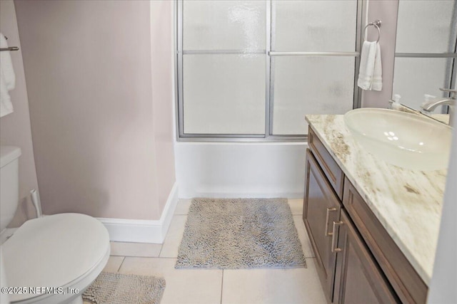 49 SW 279th Ave, Steinhatchee, FL 32359 - full bathroom with vanity, toilet, baseboards, tile patterned floors, and combined bath / shower with glass door