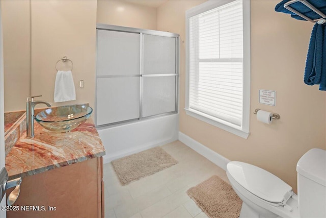 49 SW 279th Ave, Steinhatchee, FL 32359 - bathroom featuring baseboards, toilet, bath / shower combo with glass door, and vanity
