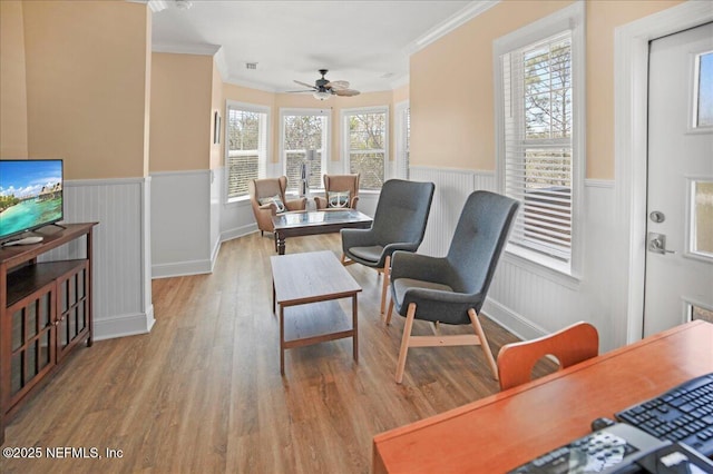 49 SW 279th Ave, Steinhatchee, FL 32359 - living area with wainscoting, crown molding, wood finished floors, and ceiling fan