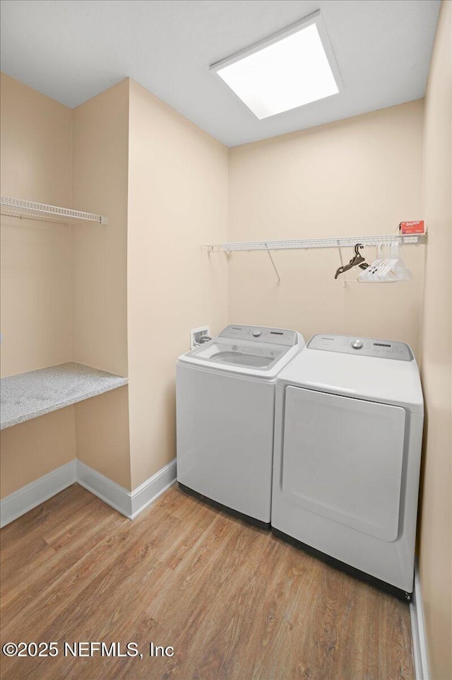 49 SW 279th Ave, Steinhatchee, FL 32359 - laundry room featuring baseboards, separate washer and dryer, light wood-style floors, and laundry area