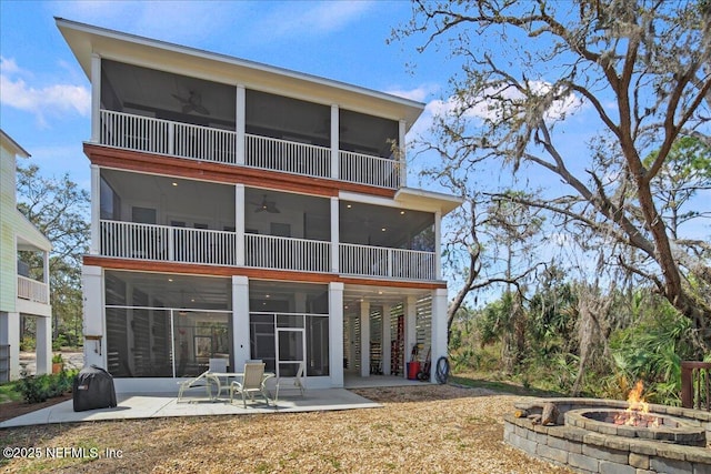 49 SW 279th Ave, Steinhatchee, FL 32359 - back of property with an outdoor fire pit, a sunroom, a patio, and a ceiling fan