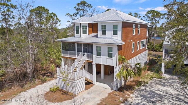 49 SW 279th Ave, Steinhatchee, FL 32359 - beach home with stairs, metal roof, and a sunroom