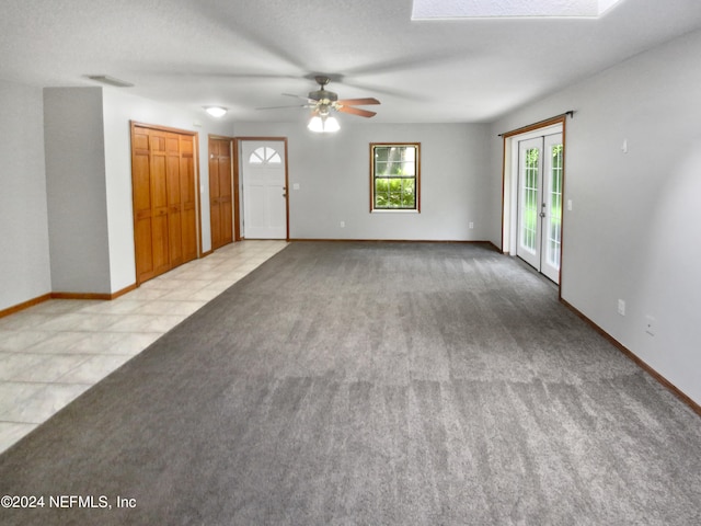 empty room featuring light colored carpet and ceiling fan