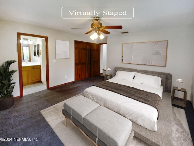 bedroom with light carpet, ceiling fan, a closet, and ensuite bath