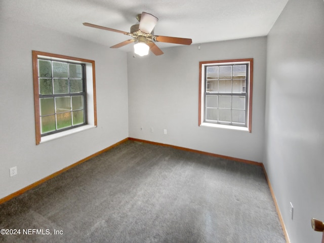 carpeted spare room with ceiling fan