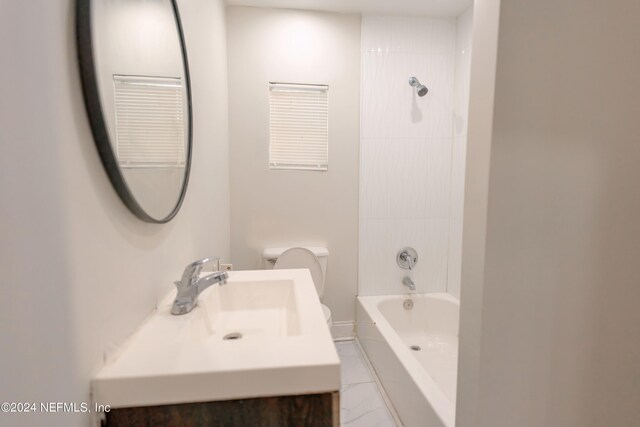 full bathroom with tiled shower / bath combo, tile patterned flooring, toilet, and vanity