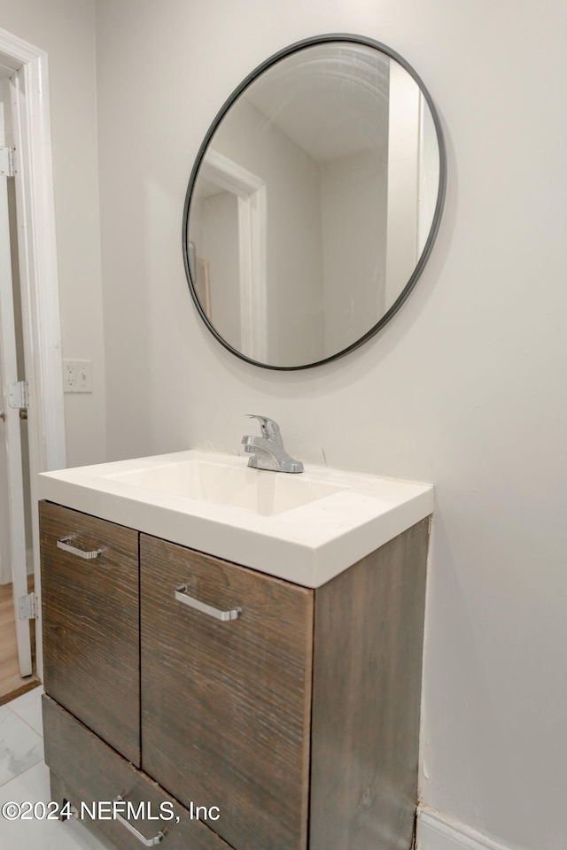 bathroom featuring tile patterned flooring and vanity