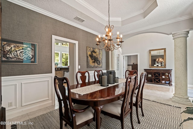 dining space with light tile patterned floors, decorative columns, visible vents, and wainscoting