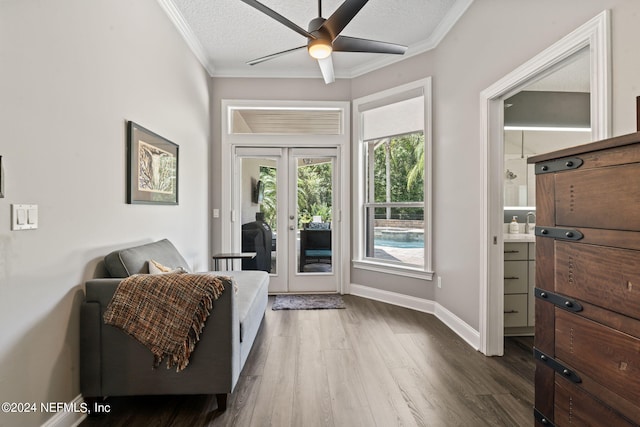 entryway featuring a textured ceiling, wood finished floors, baseboards, french doors, and crown molding